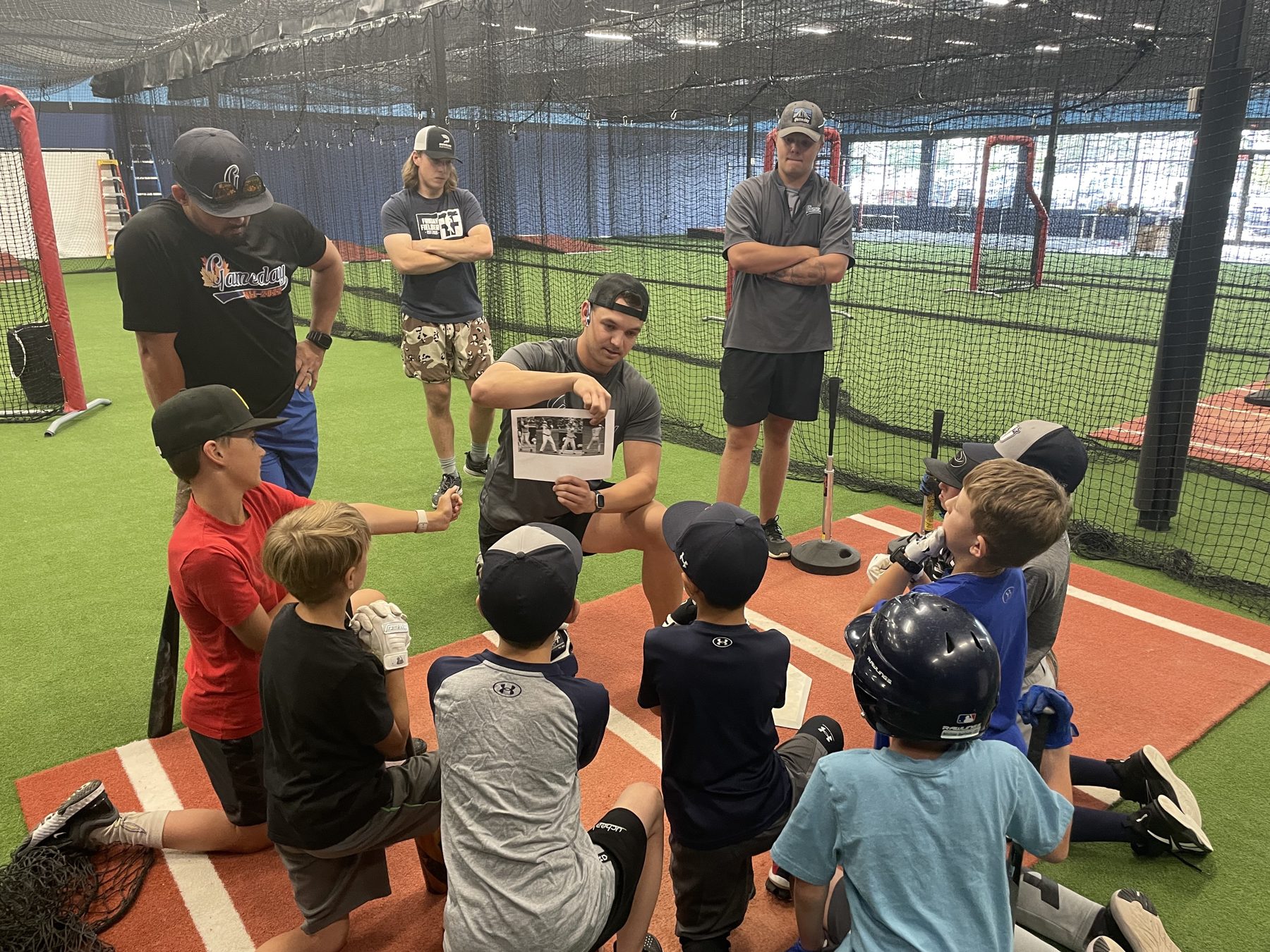 Gameday coach teaching young players in the indoor training facility